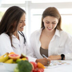 Women's personalized nutrition research consultation with doctor discussing gut health and microbiome science