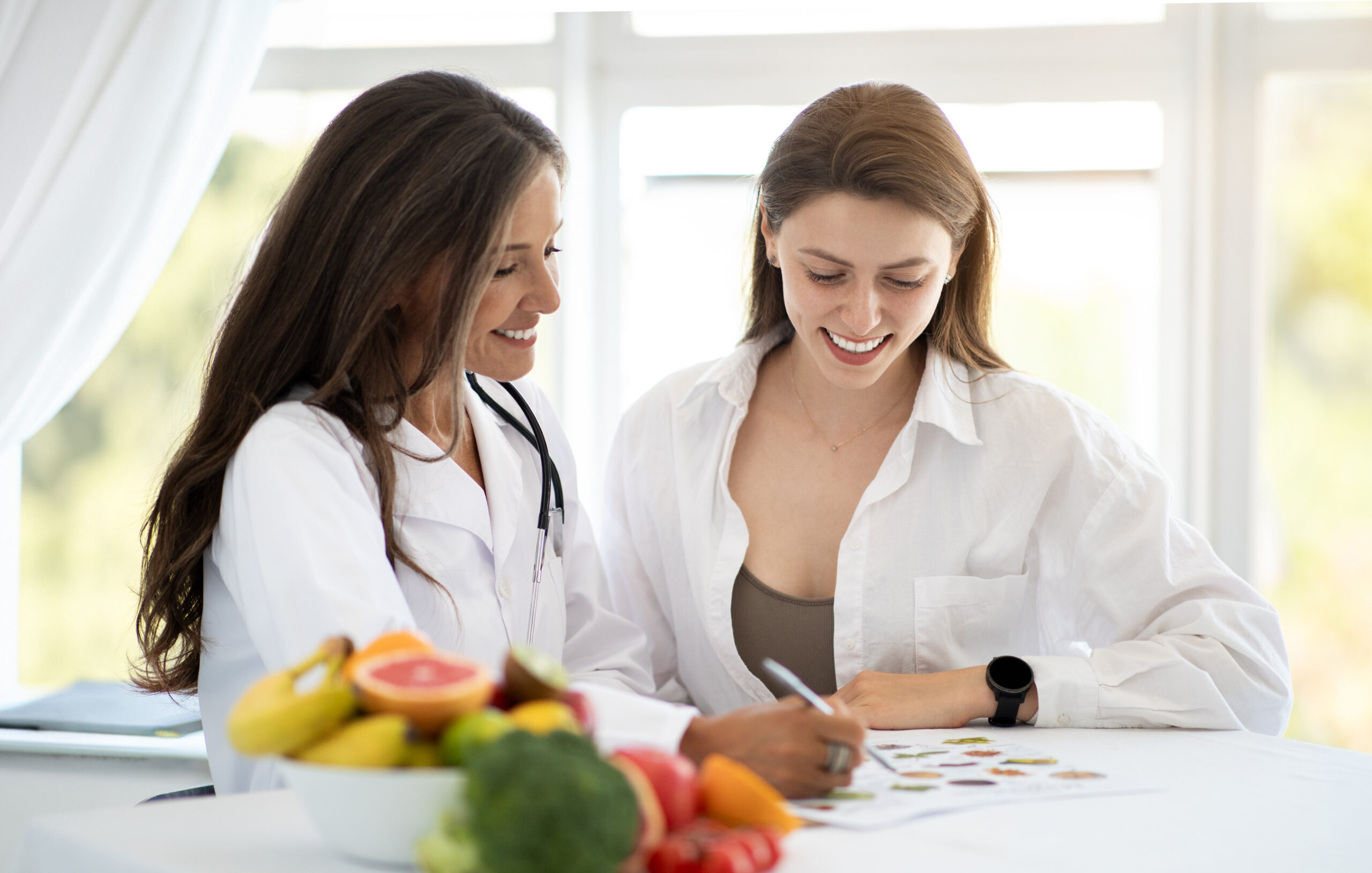 Women's personalized nutrition research consultation with doctor discussing gut health and microbiome science