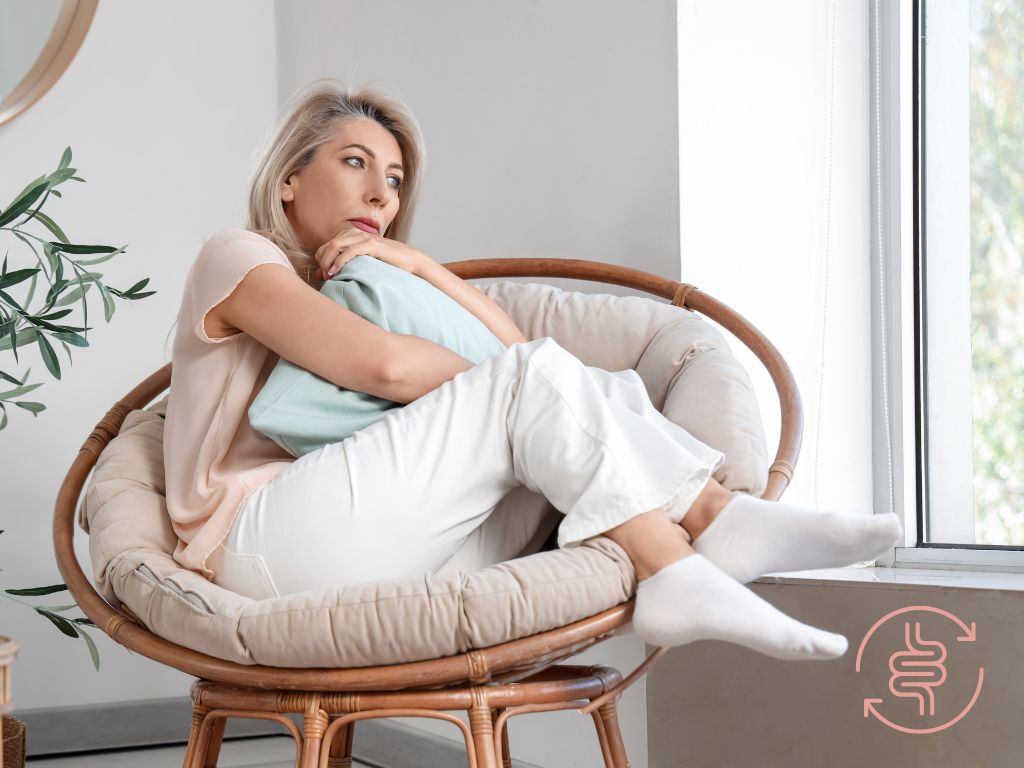 Woman experiencing IBS vs SIBO symptoms bloating discomfort