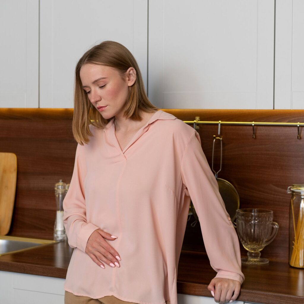 Woman experiencing bloating and digestive discomfort - signs your gut needs support